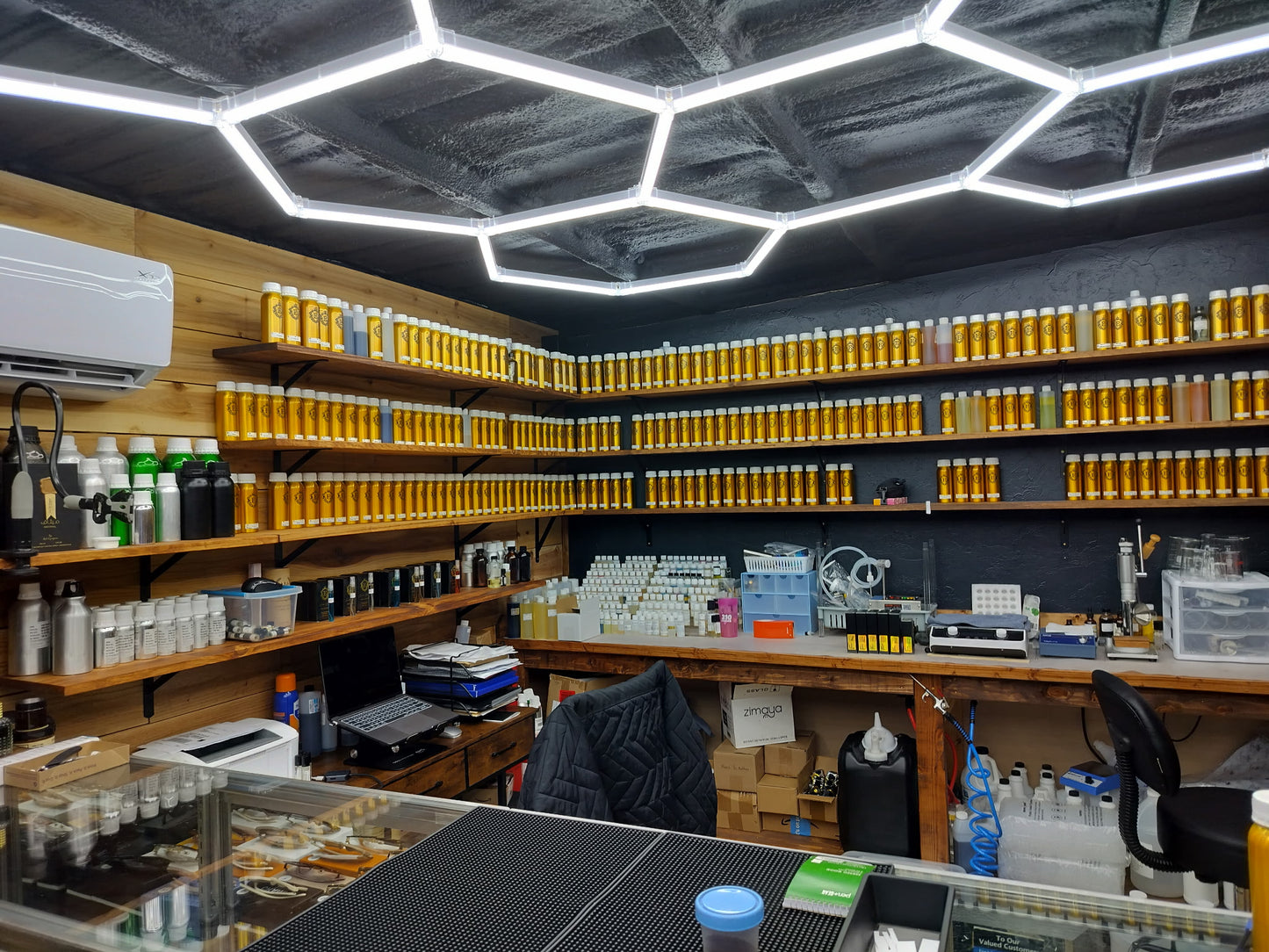 Drugstore interior with shelves stocked with various products and a hexagonal ceiling design.
