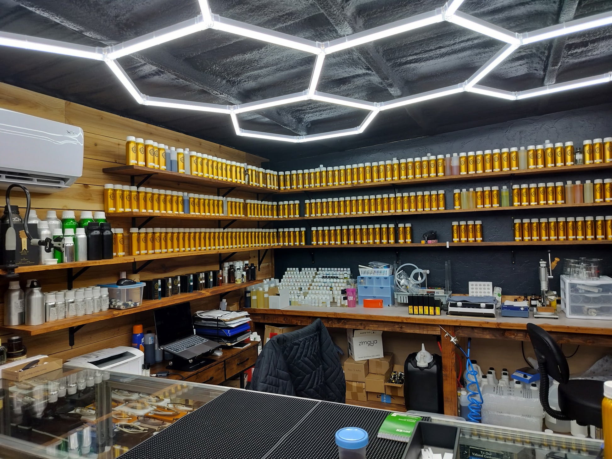 Drugstore interior with shelves stocked with various products and a hexagonal ceiling design.